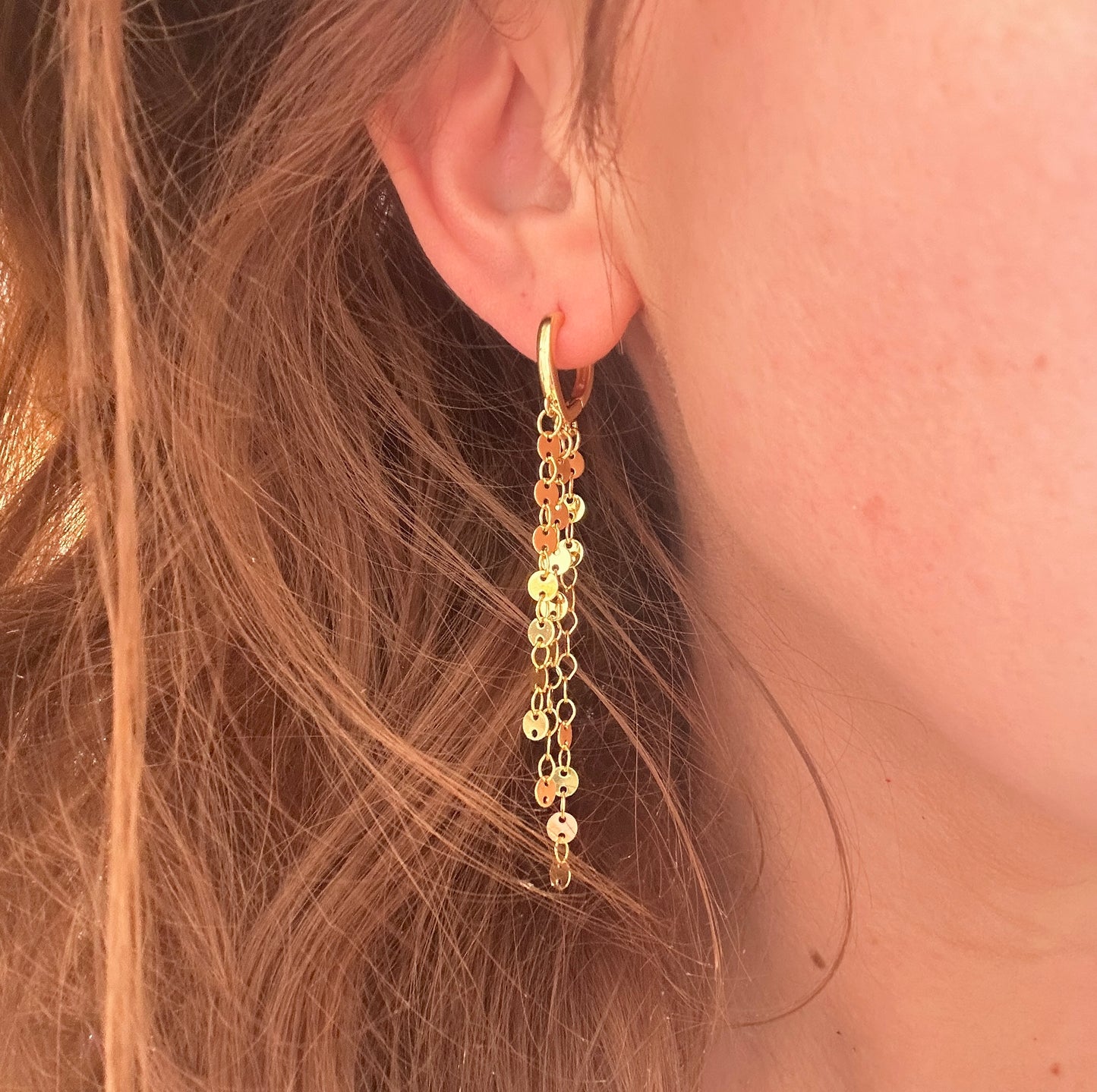 Gold glitzy chain drop huggie earrings.