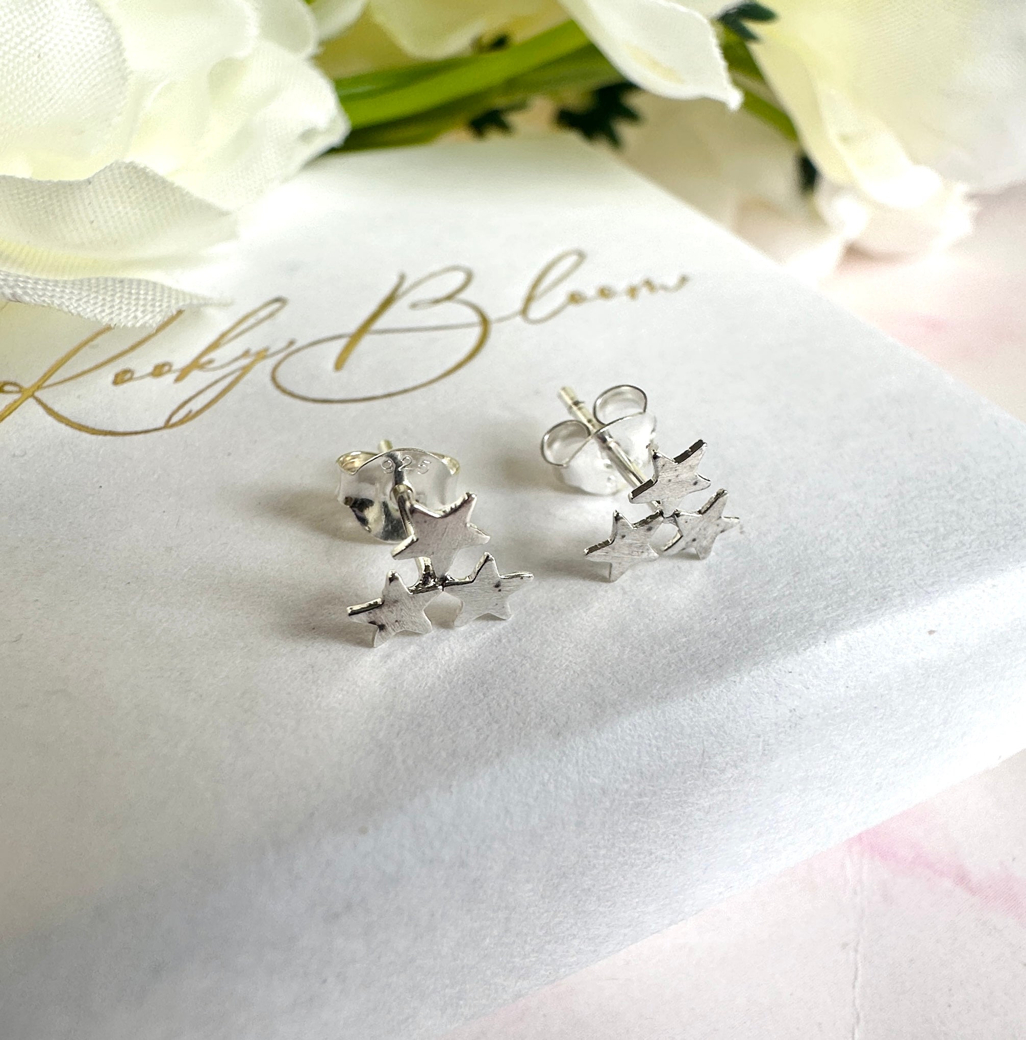 925 sterling silver tiny triple star stud earrings.