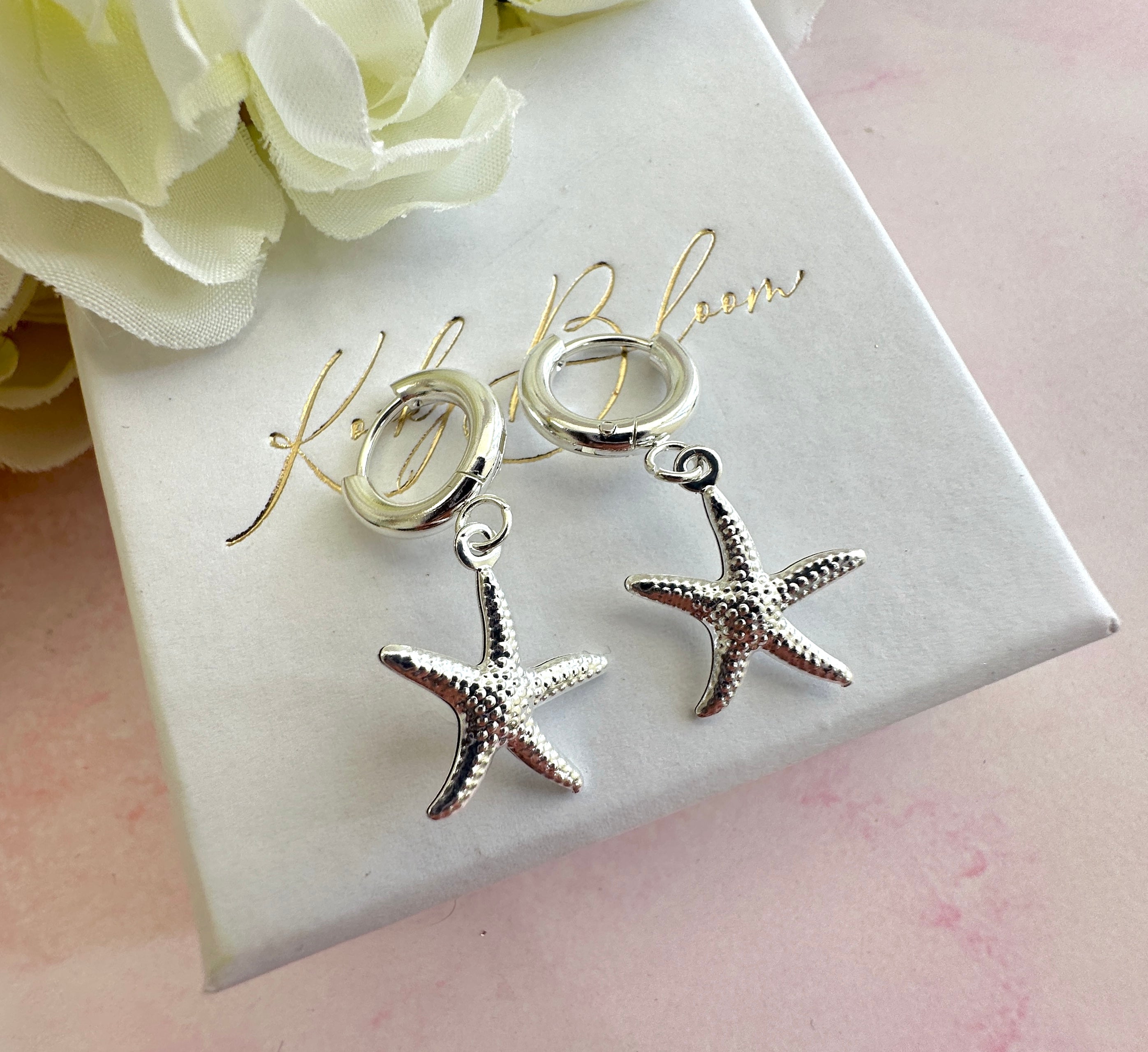 Silver starfish chunky Huggie hoop earrings.