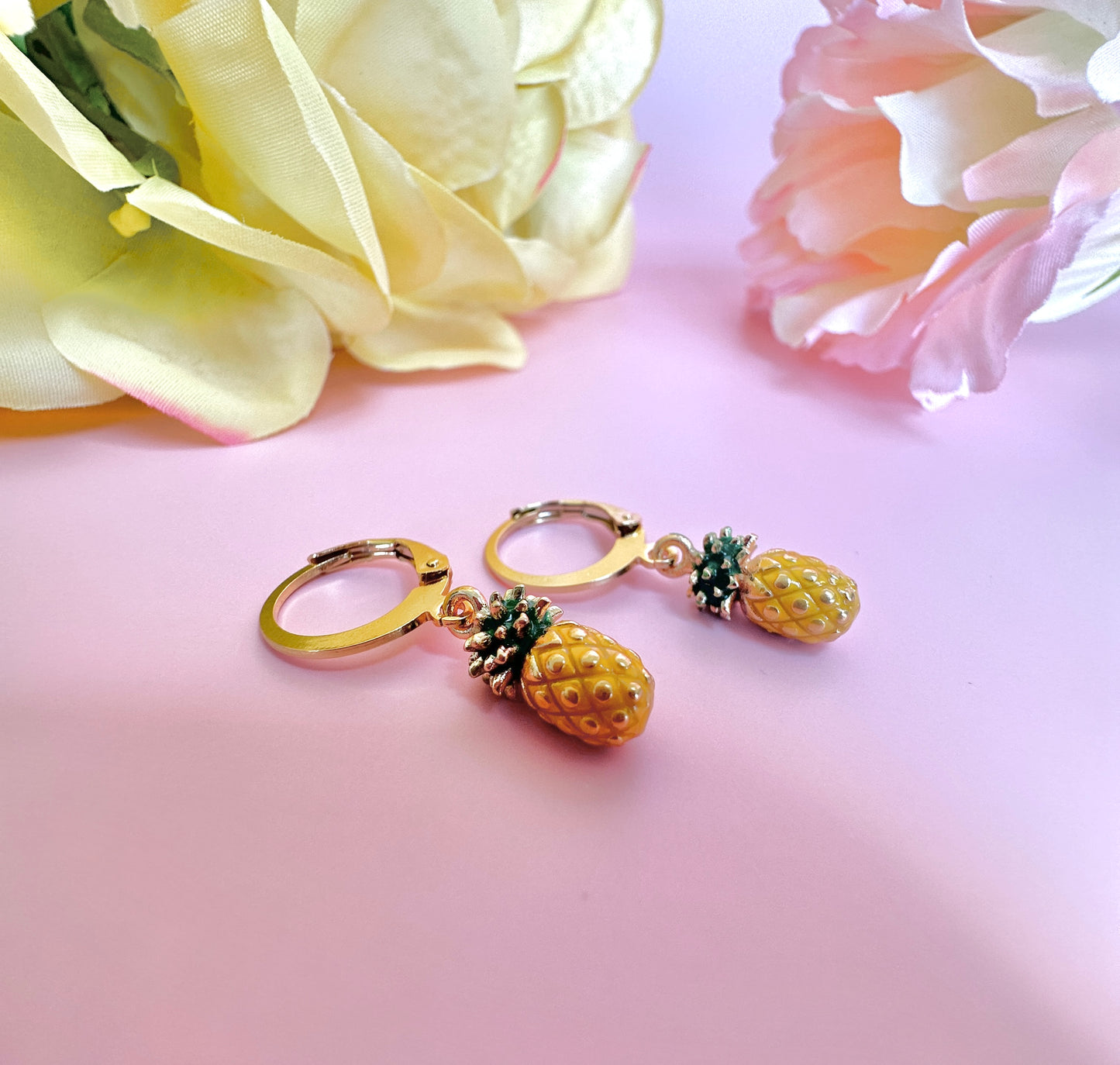 Tiny enamel pineapple gold huggie earrings.