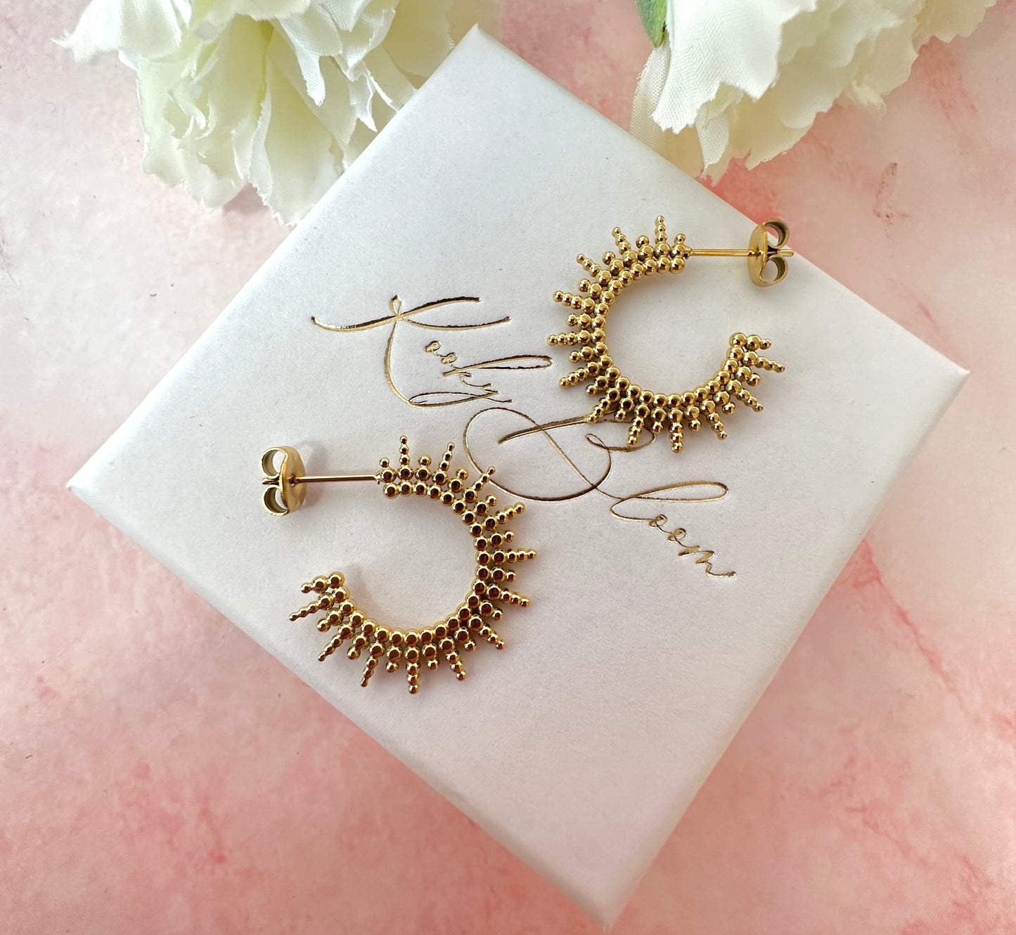 Gold sun ray earrings.