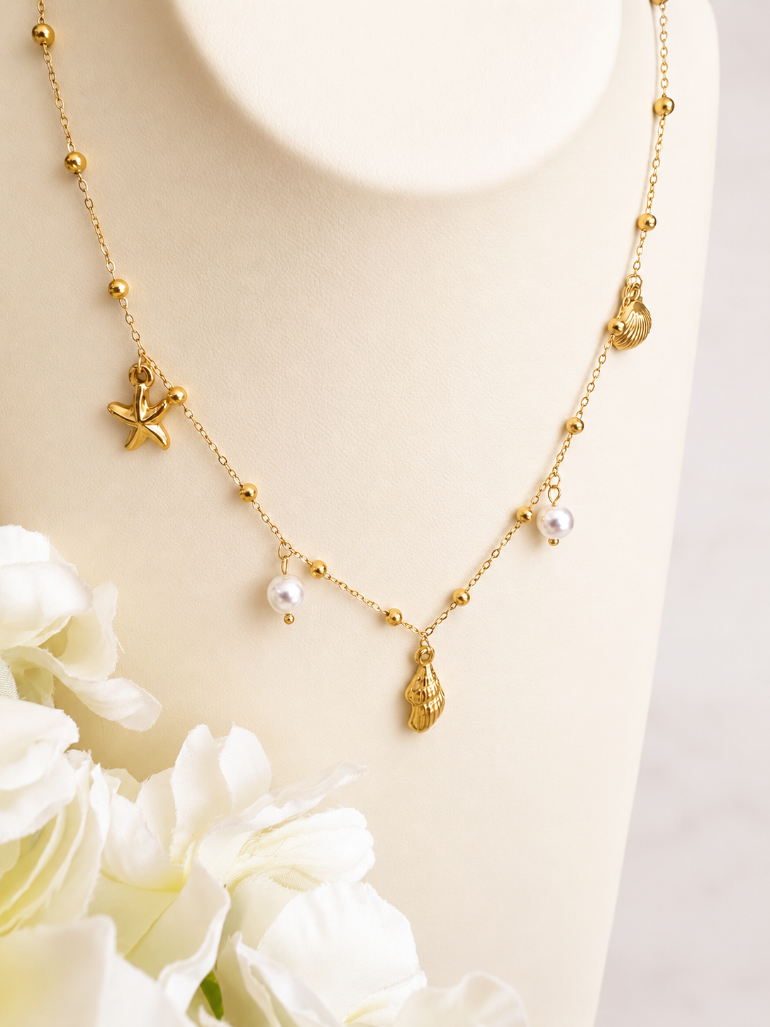 Gold seashell starfish pearl charm necklace.