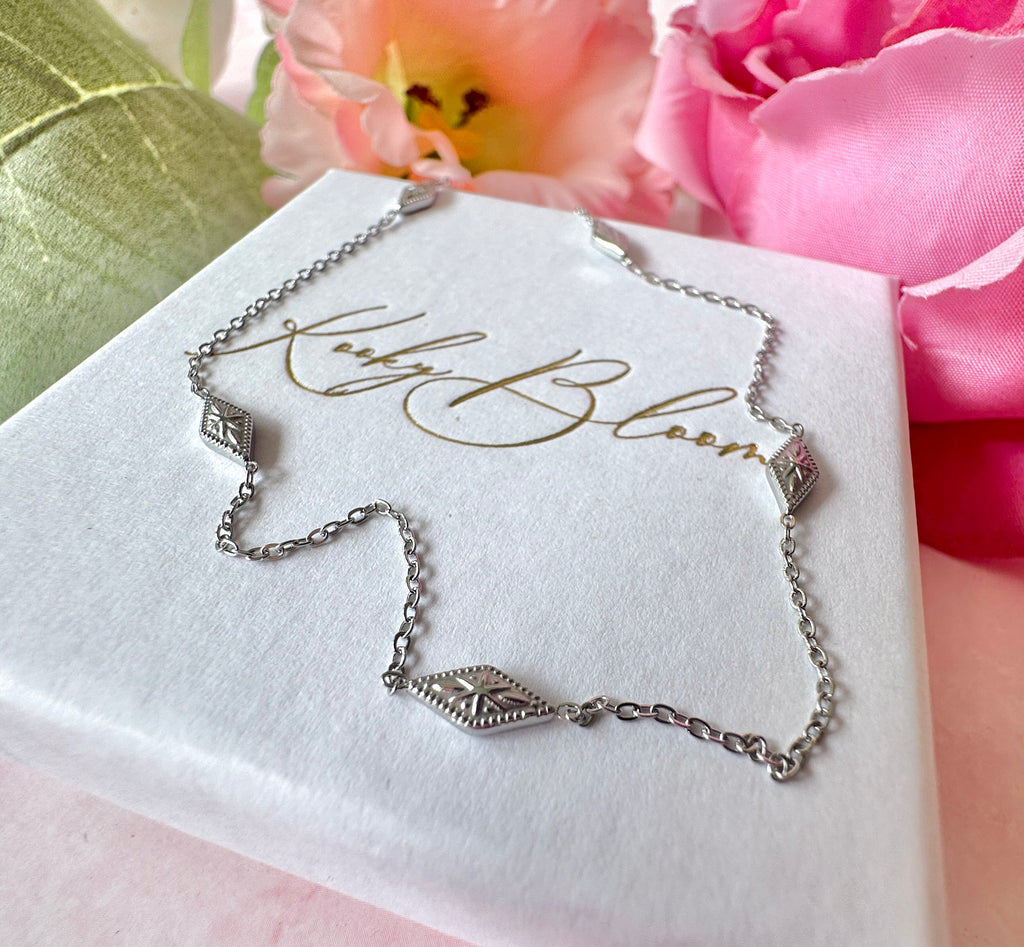 Silver dainty engraved star diamond necklace.