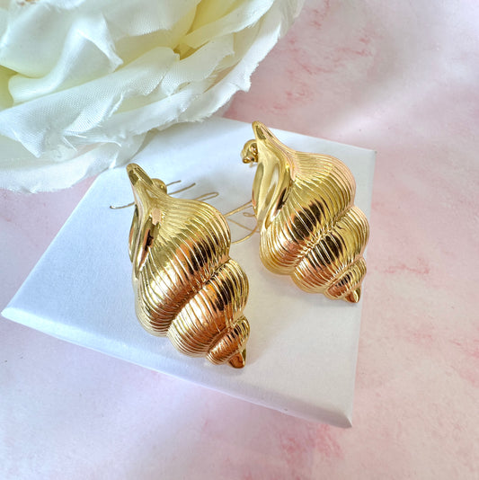 Gold oversized Seashell stud earrings.