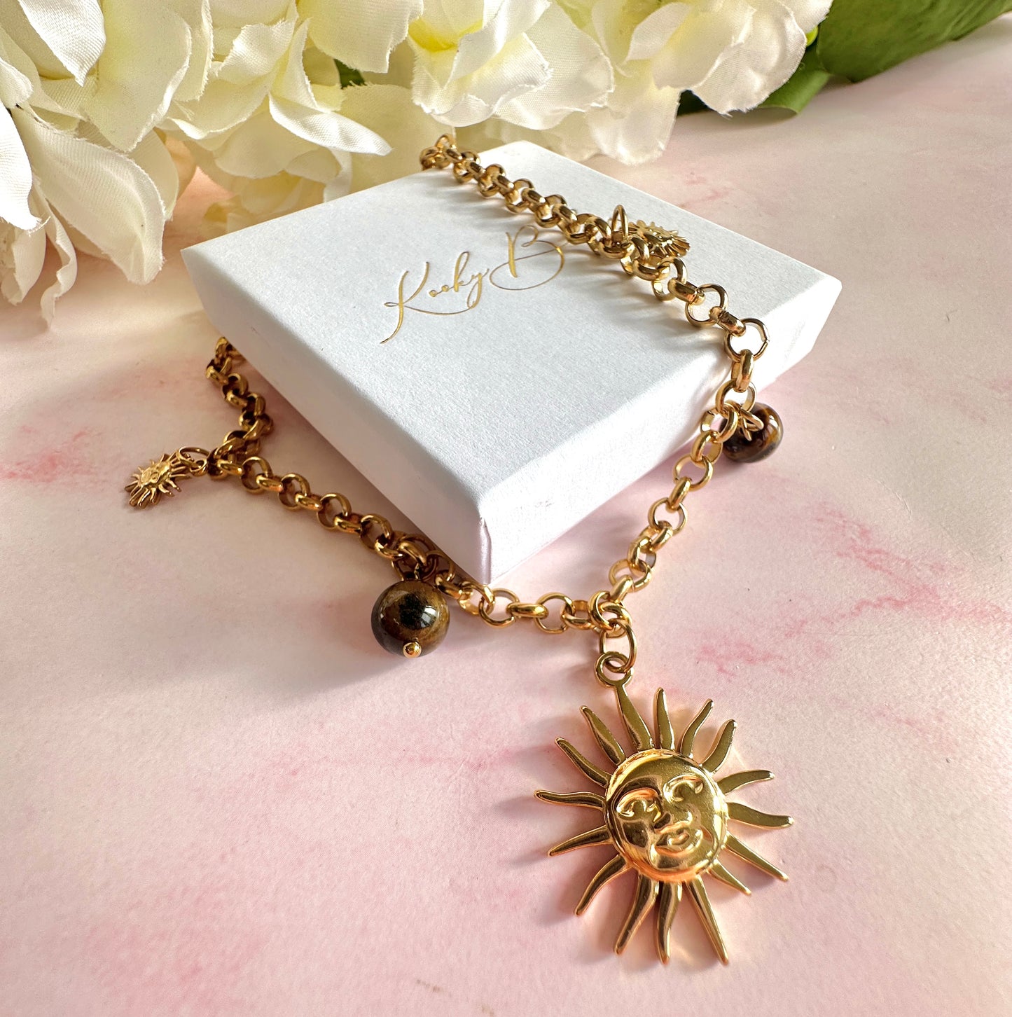 Gold chunky Sun charm necklace.