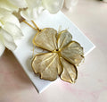 Gold pearlescent oversized flower necklace.