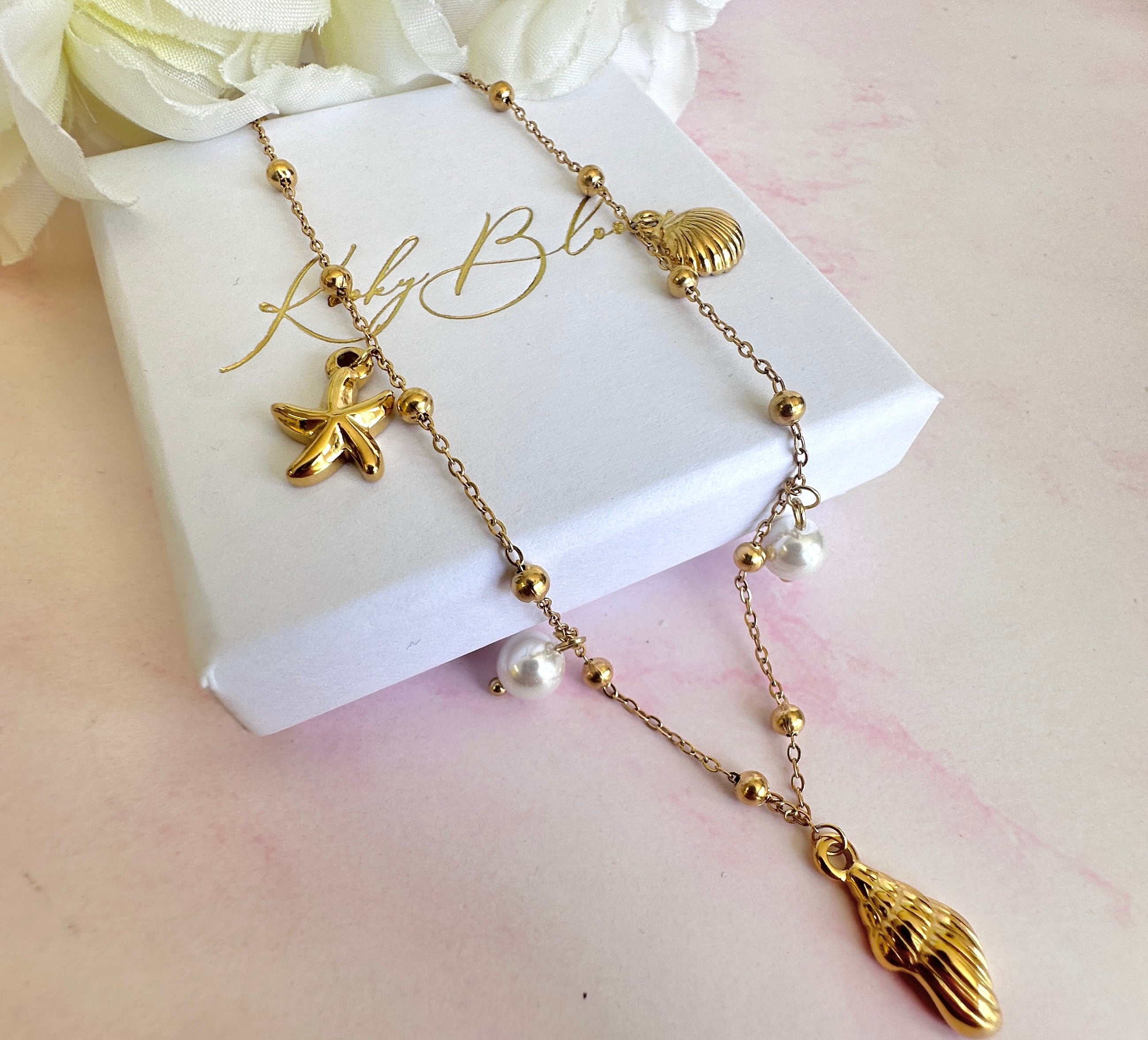 Gold seashell starfish pearl charm necklace.
