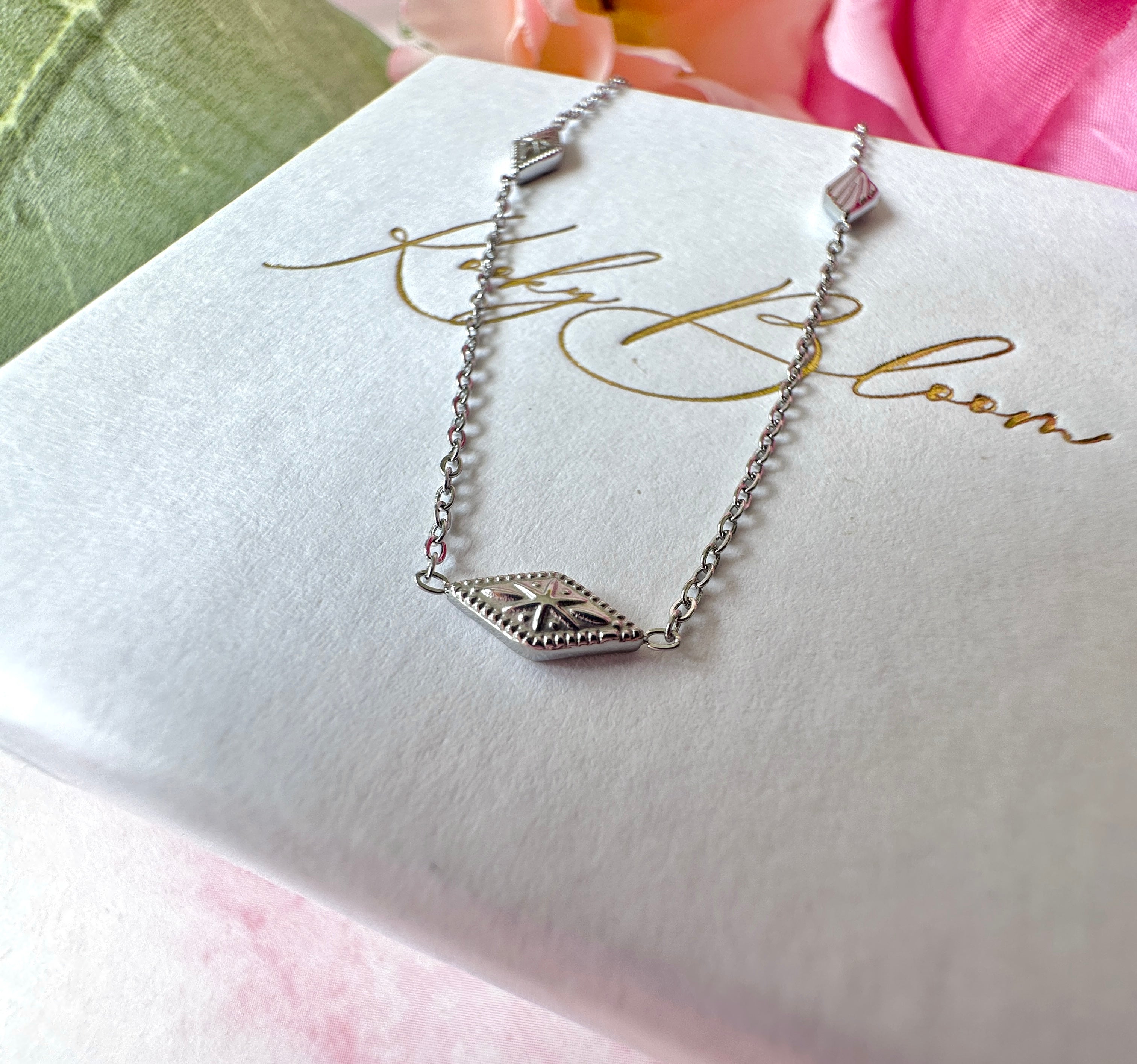 Silver dainty engraved star diamond necklace.