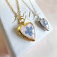 Gold forget me not flower heart locket necklace.