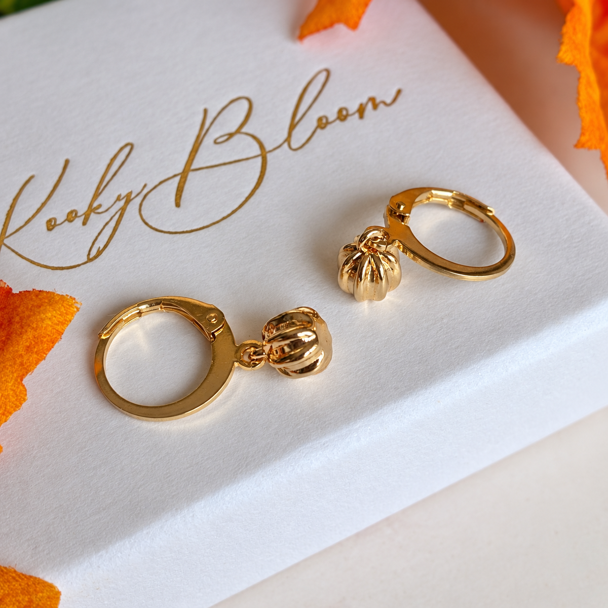 Gold Teeny pumpkin Huggies.