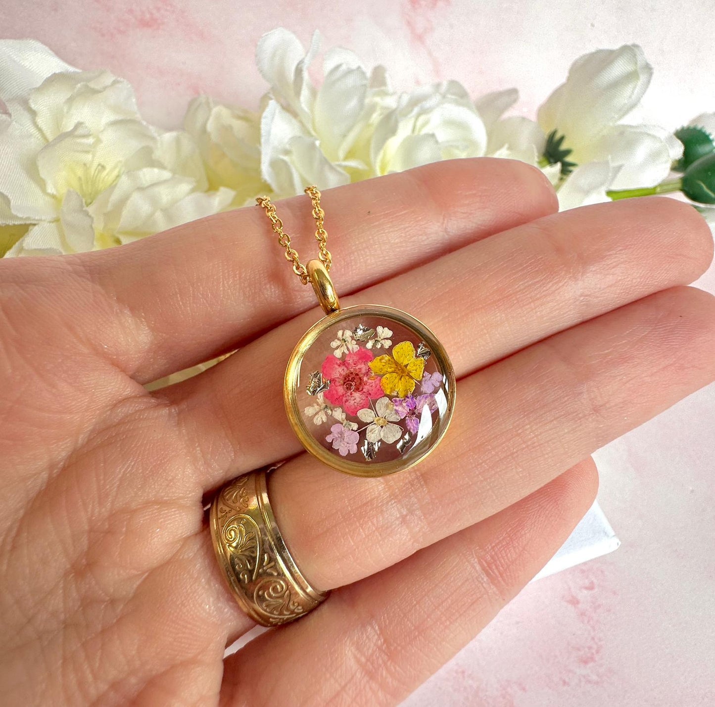 Gold real flower capsule locket necklace.