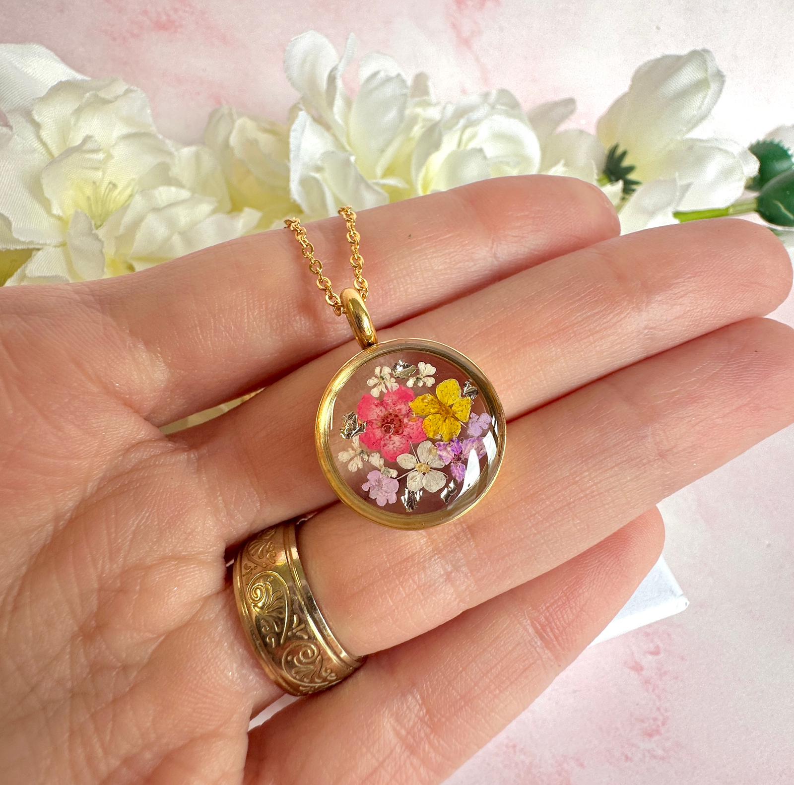 Gold real flower capsule locket necklace.