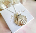 Silver ceramic seashell necklace.
