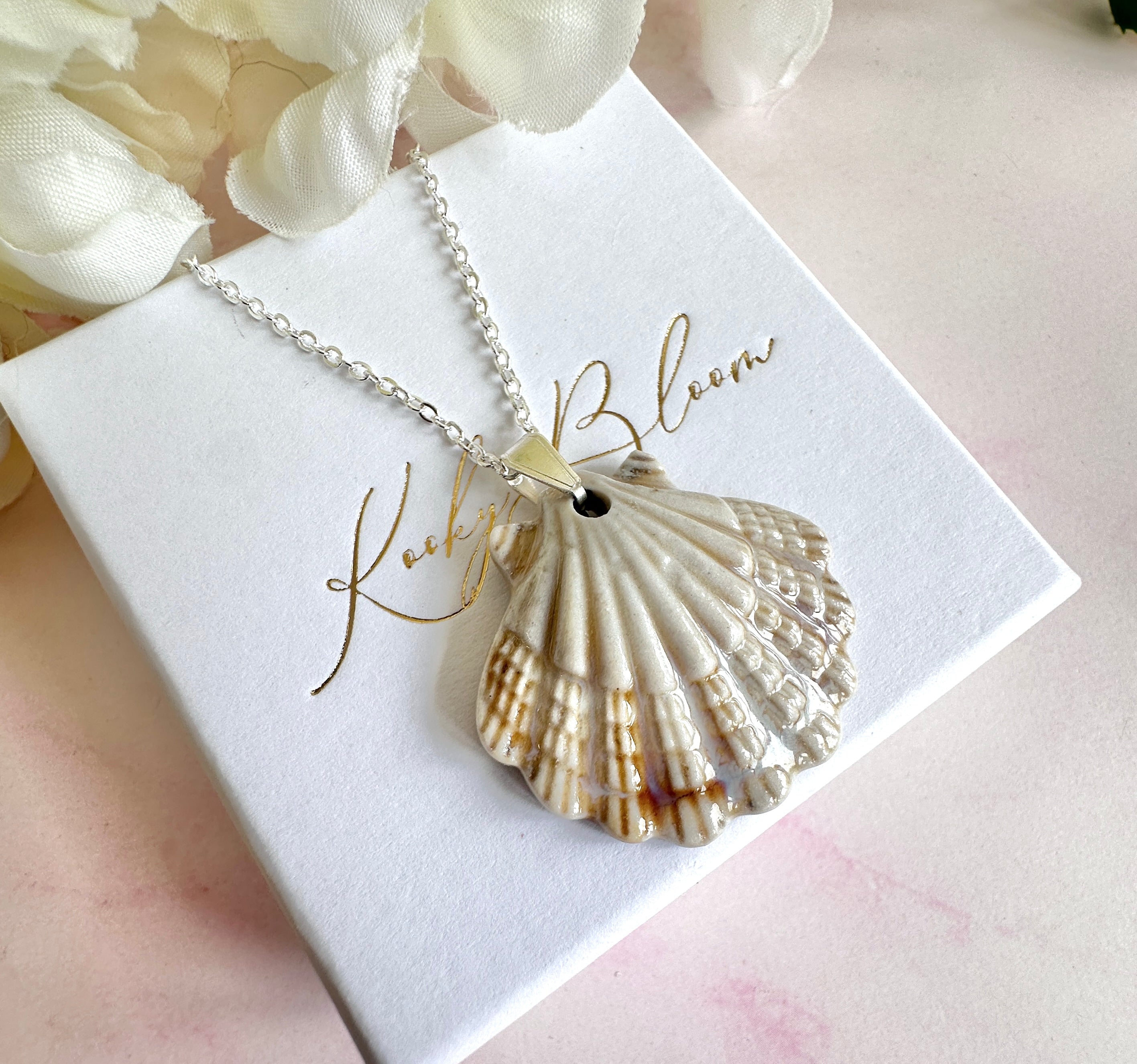 Silver ceramic seashell necklace.