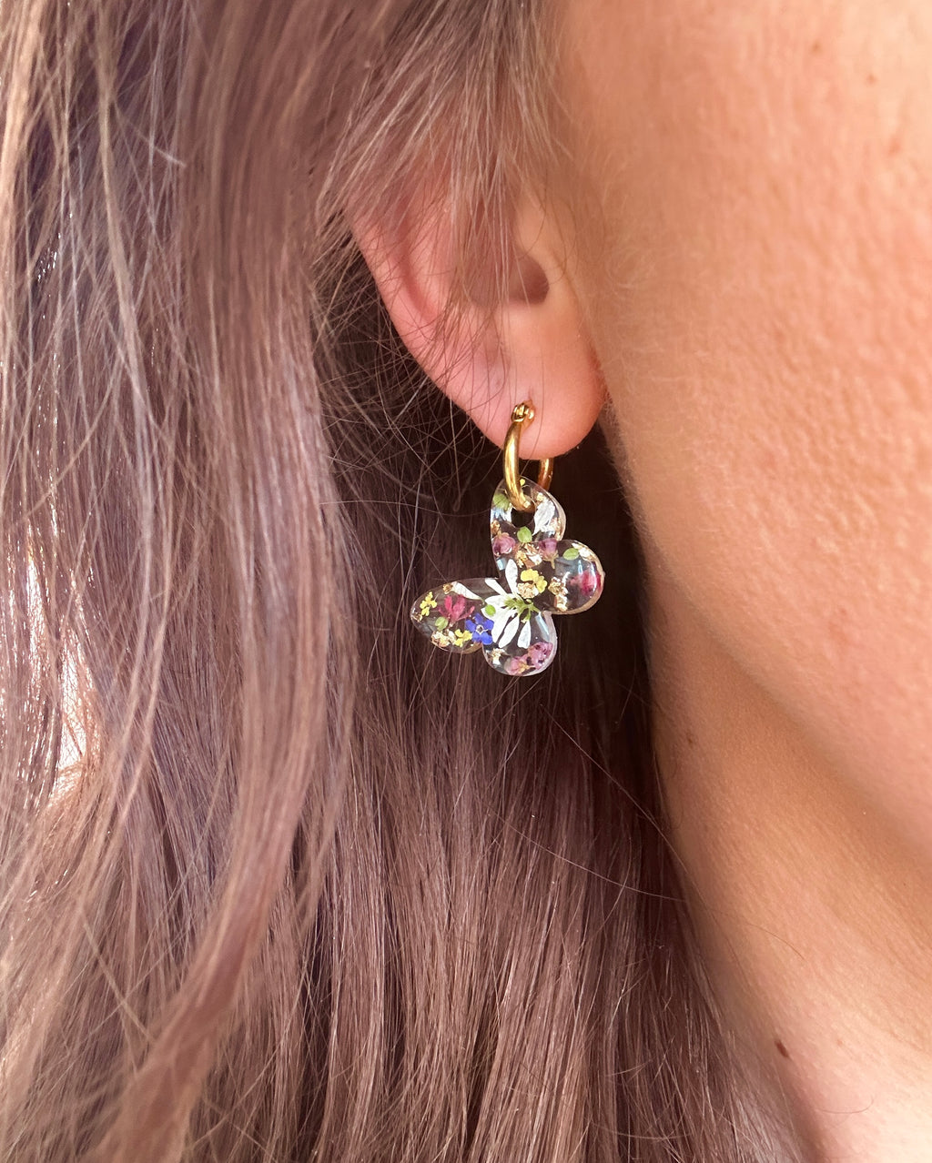 Butterfly flower confetti bloom hoop earrings.