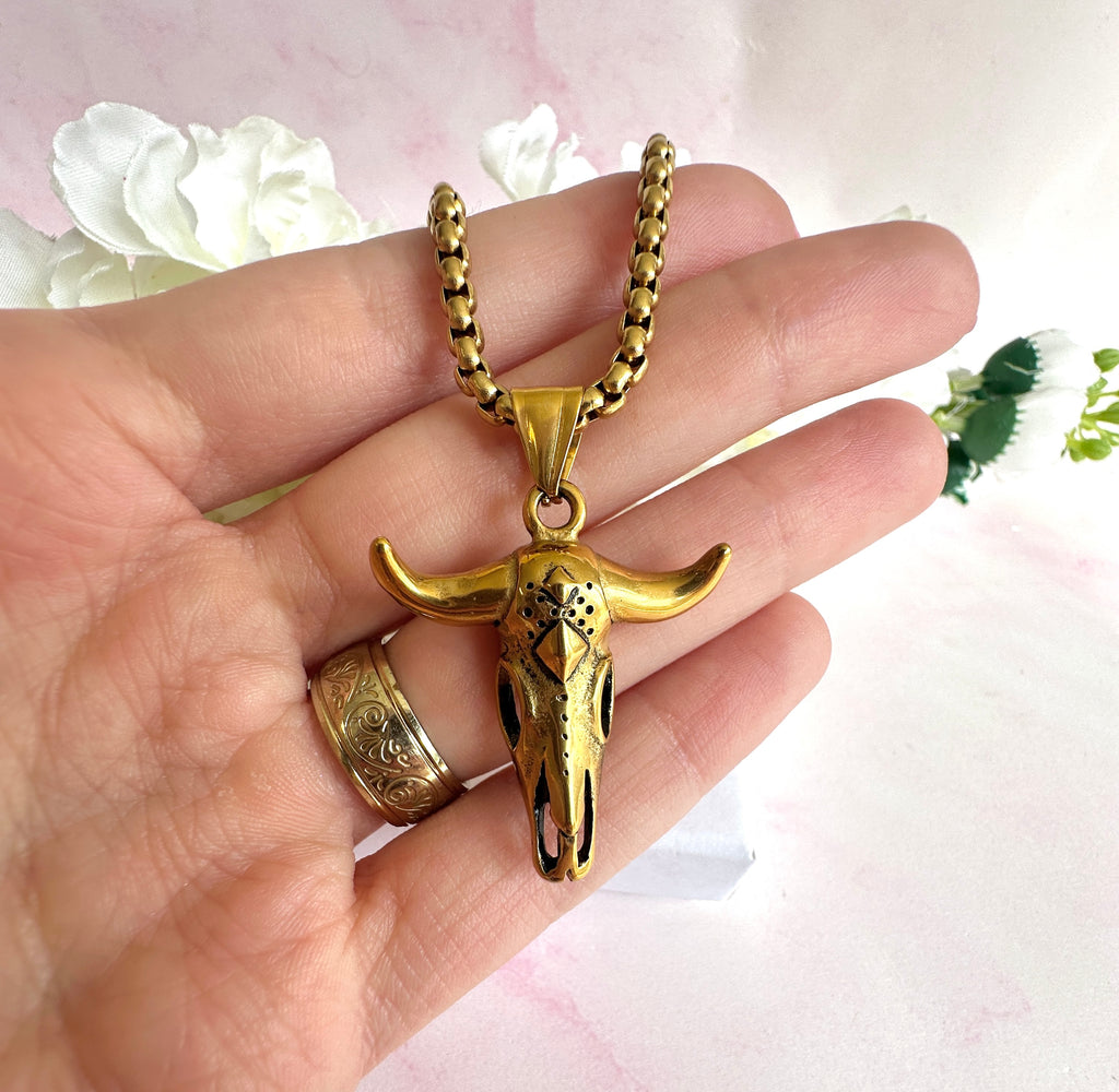 Gold longhorn necklace.