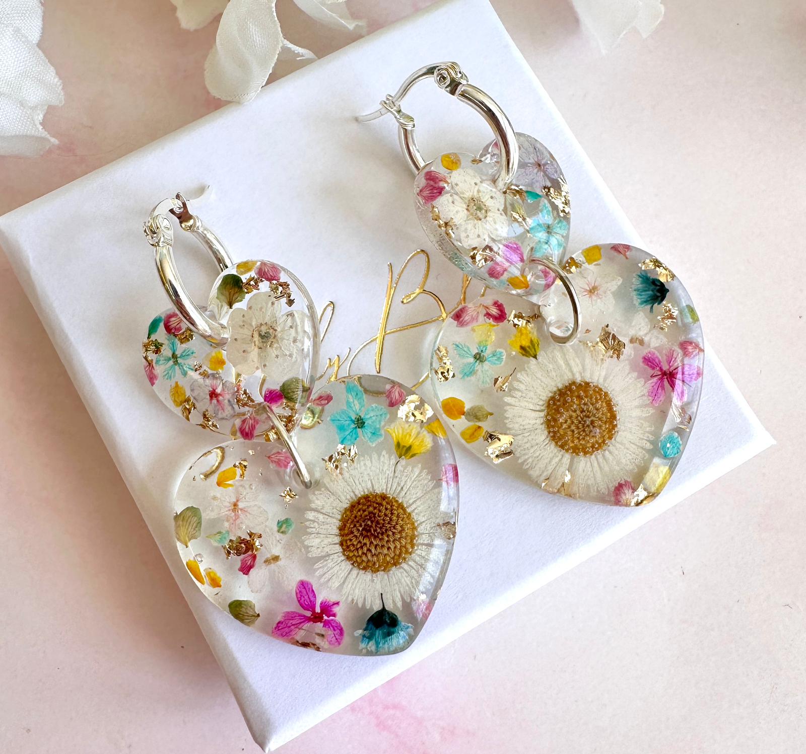 Daisy confetti double heart drop hoop earrings.