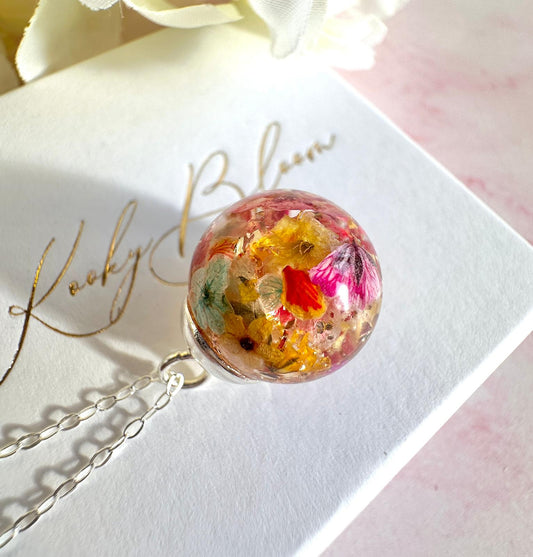 Silver Flower confetti Globe necklace.