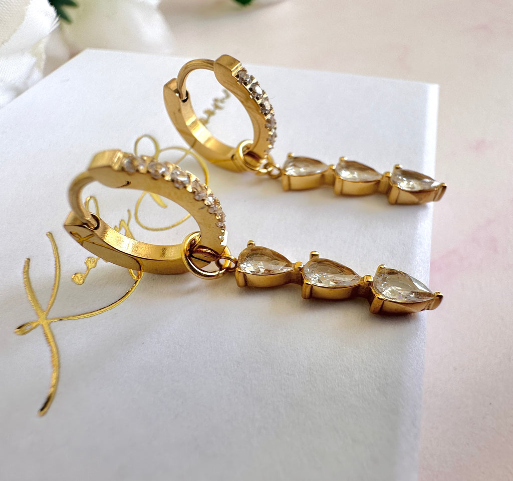 Gold Triple CZ Drop huggie earrings.