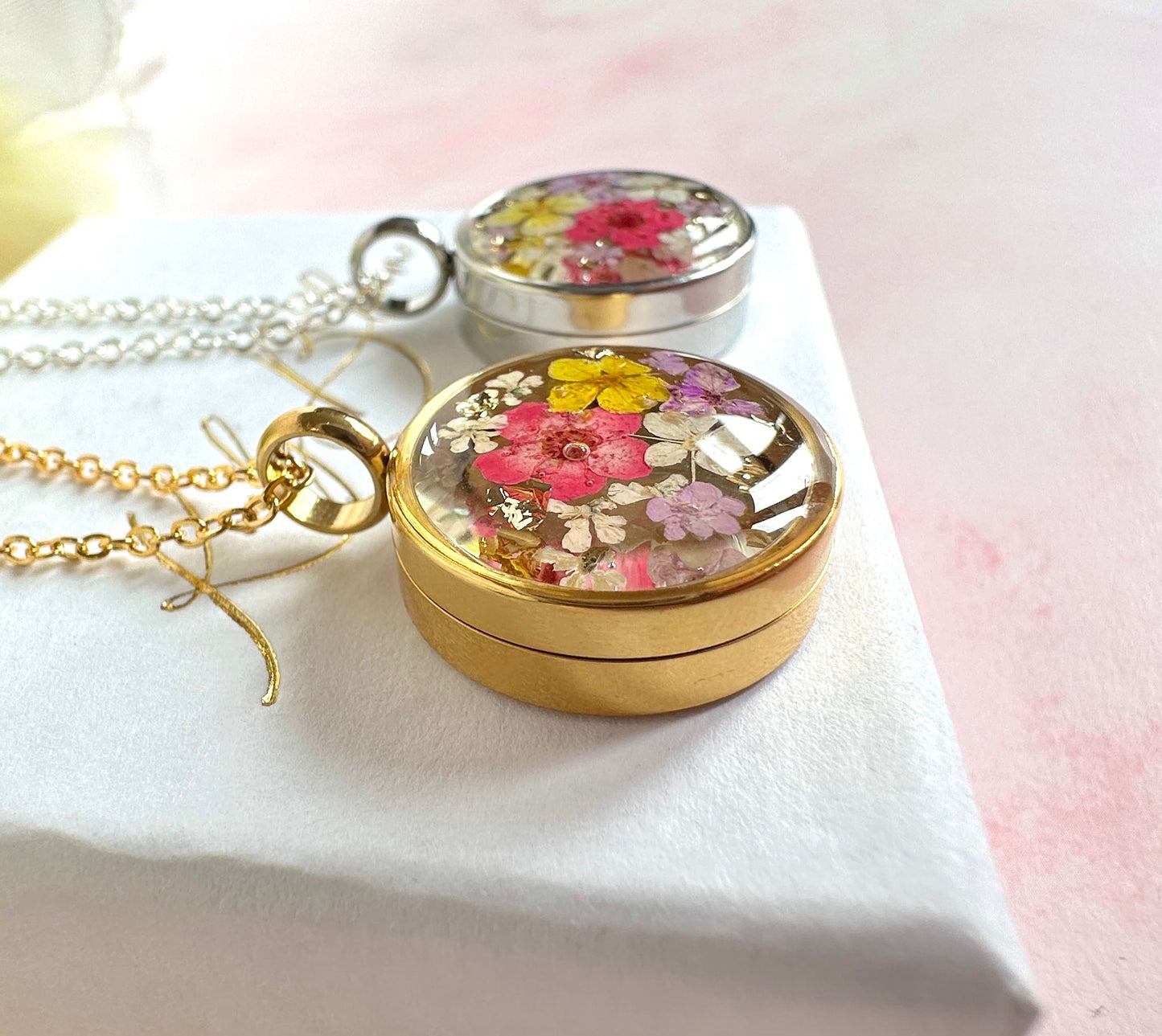 Gold real flower capsule locket necklace.