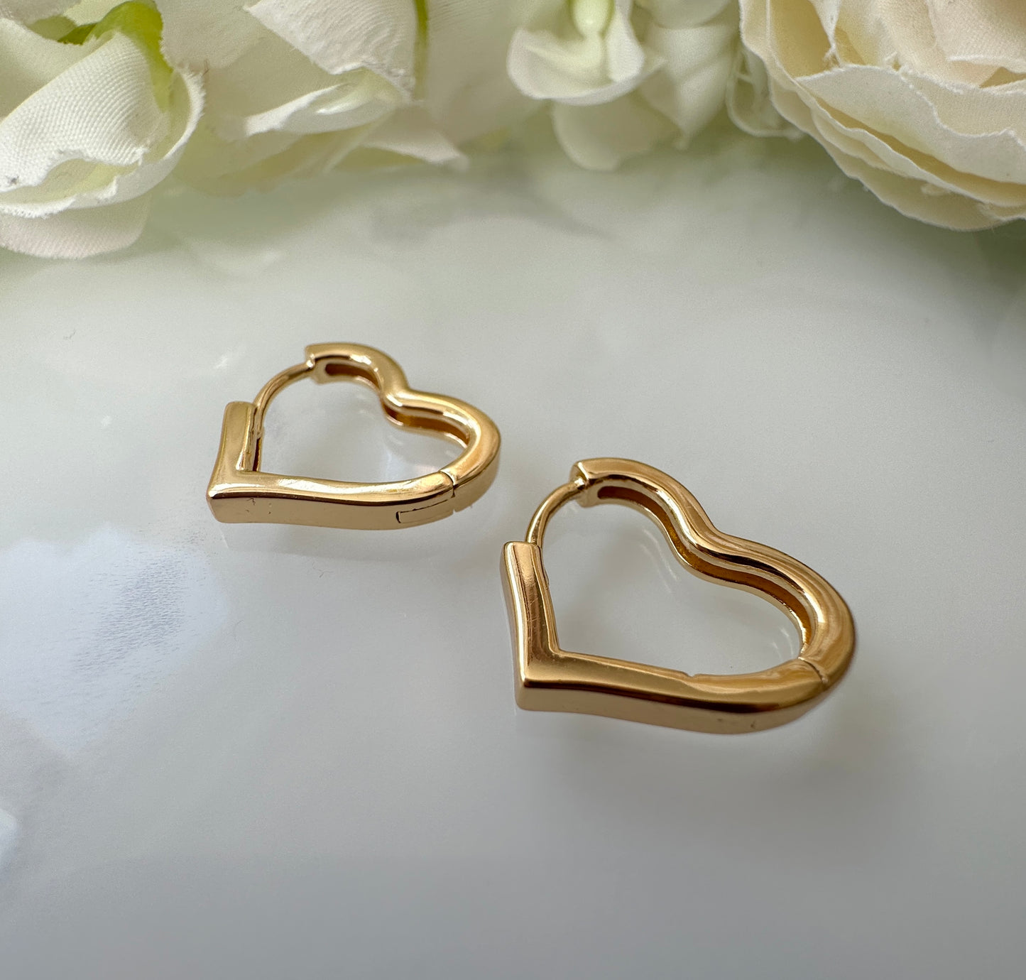 Gold Heart shape Huggie Hoop earrings.