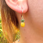Tiny enamel pineapple gold huggie earrings.