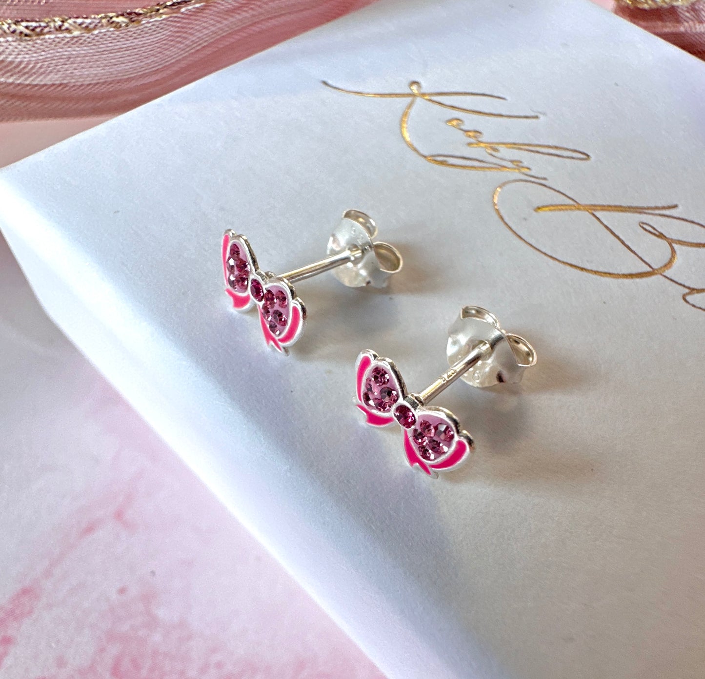 925 Sterling Silver Pink bow stud earrings.