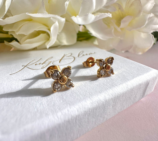 Gold CZ flower stud earrings.