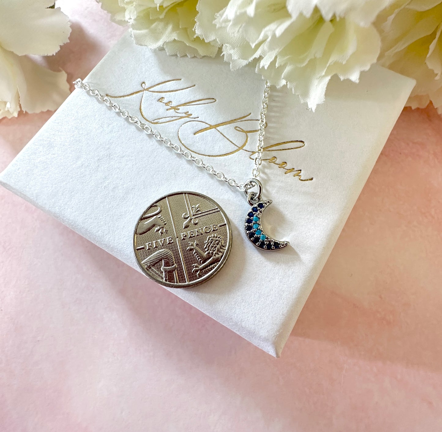Silver tiny blue stone Moon necklace.