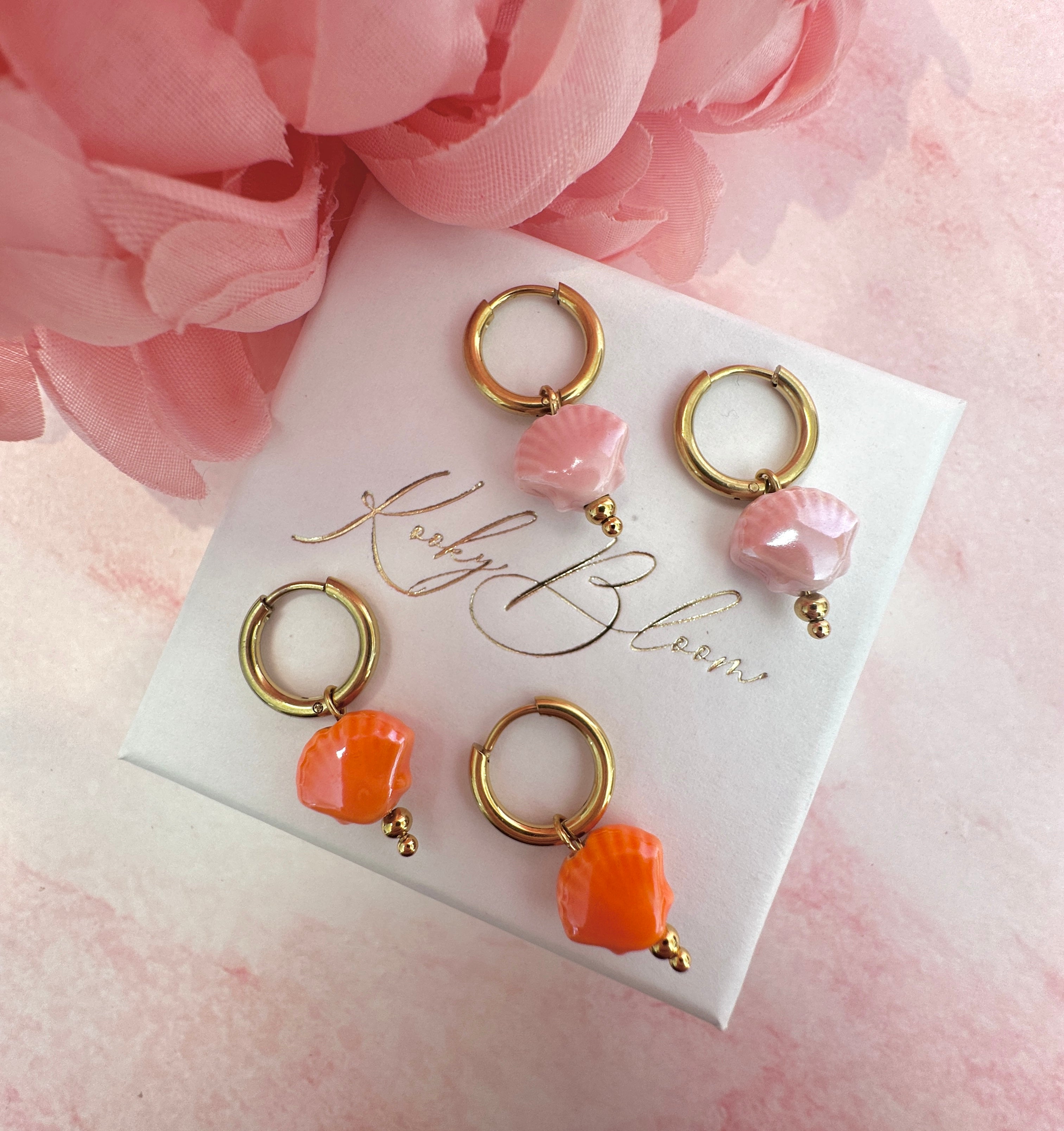 Gold ceramic seashell bead earrings.