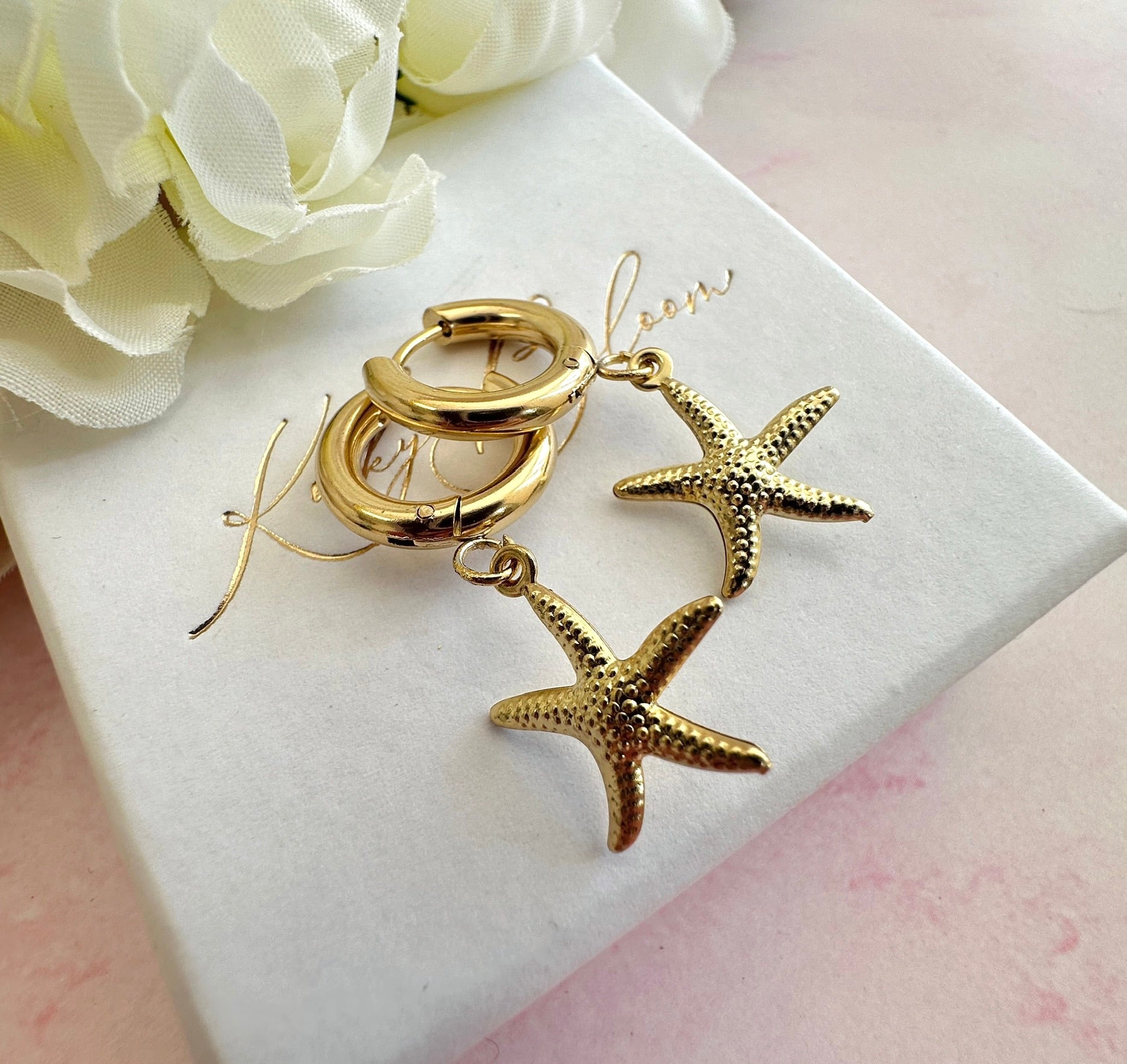 Gold starfish chunky Huggie hoop earrings.