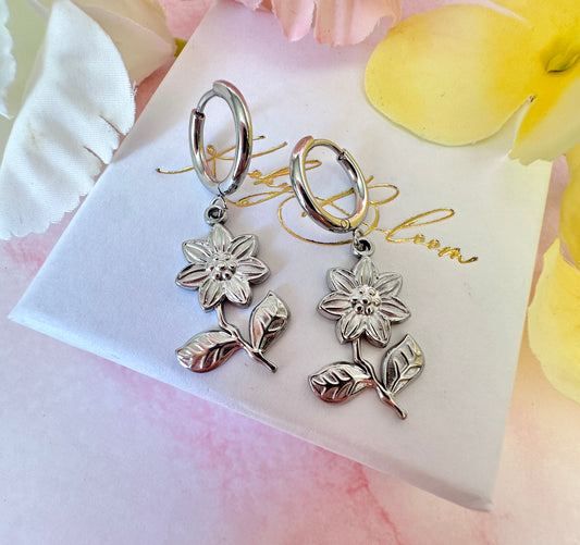 Silver flower drop hoop earrings.