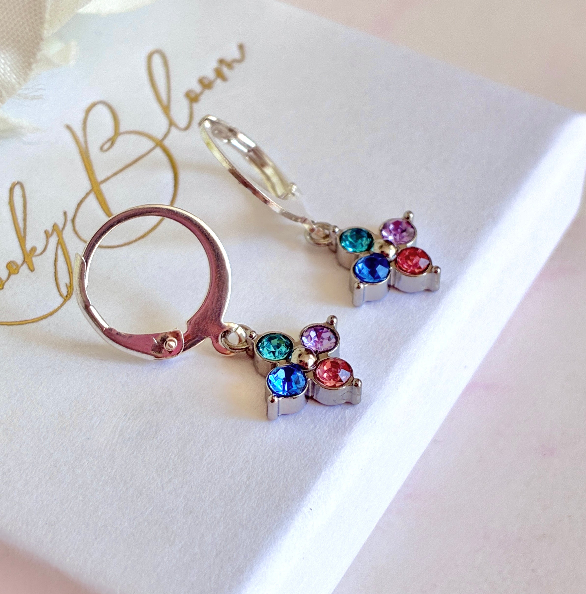 Silver pastel Quad Stone huggie earrings.