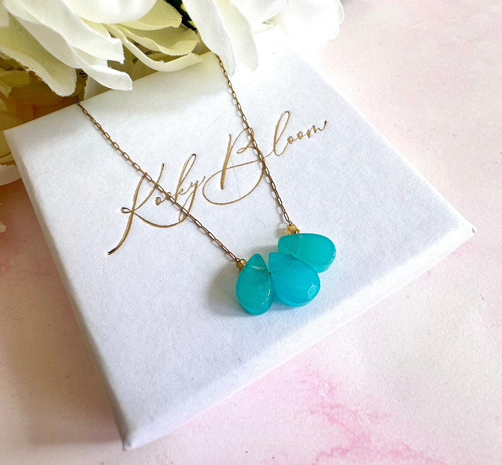 Gold triple aqua gemstone necklace.