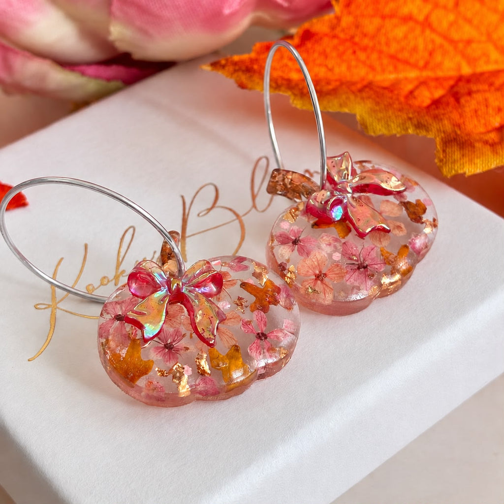 Rosie Bloom Bow Pumpkin hoop earrings.