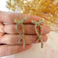 Gold long diamanté Bow stud earrings.
