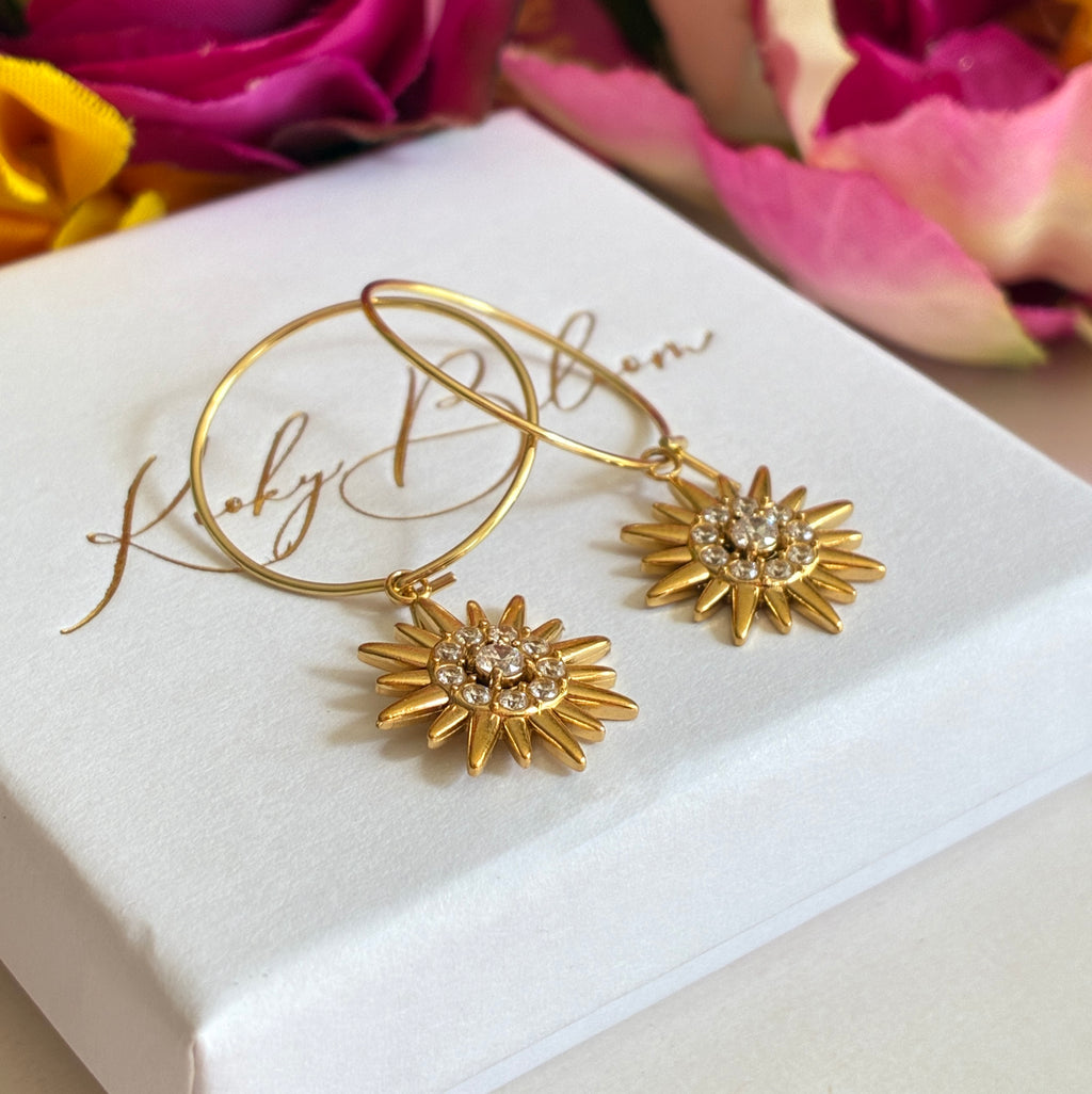 Gold CZ Star sun ray earrings.