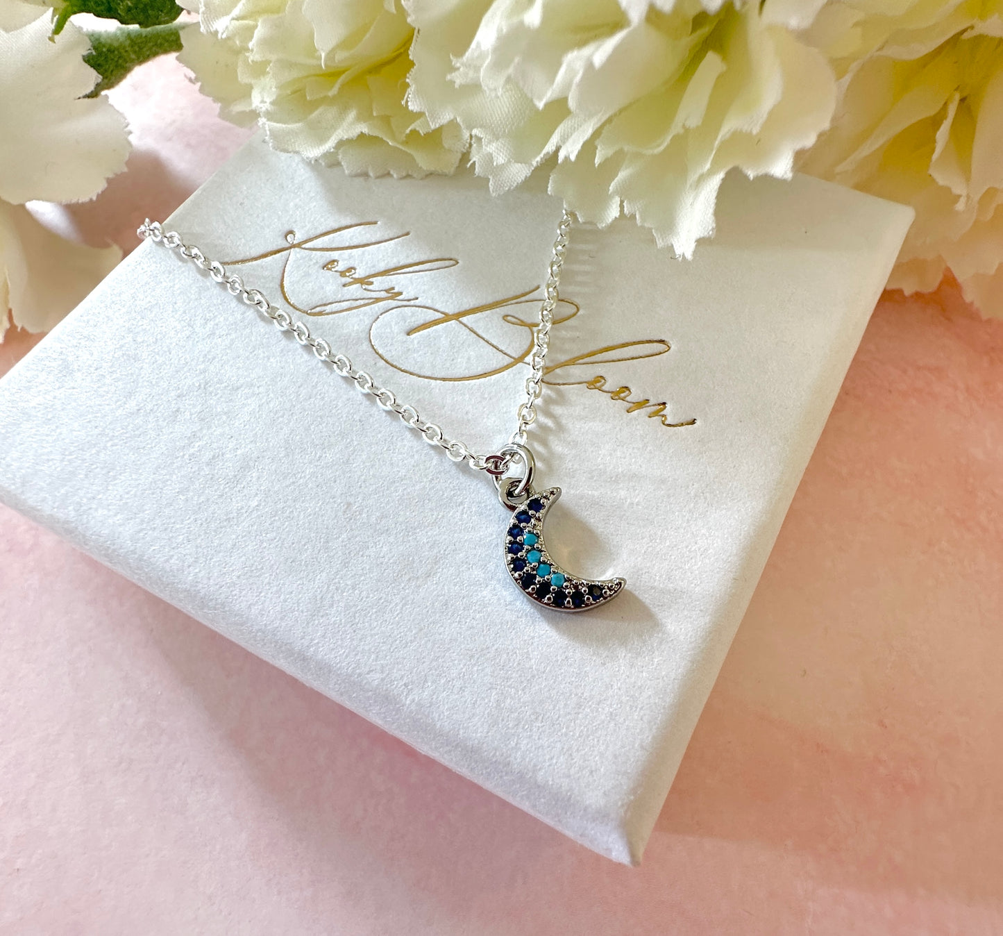 Silver tiny blue stone Moon necklace.