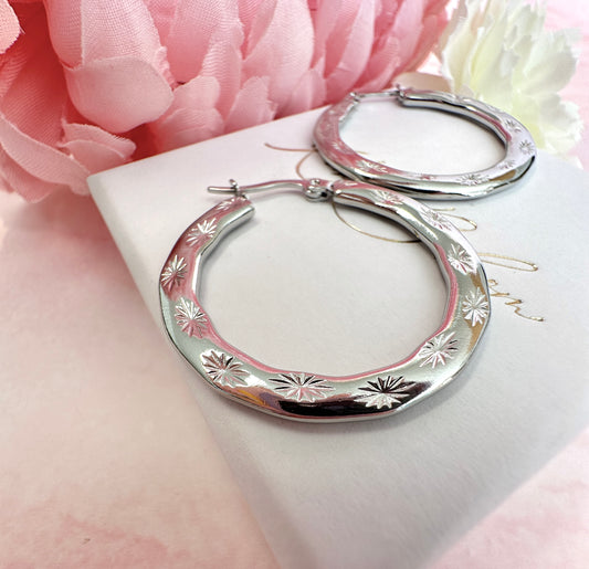 Silver Engraved starburst Hoop earrings.