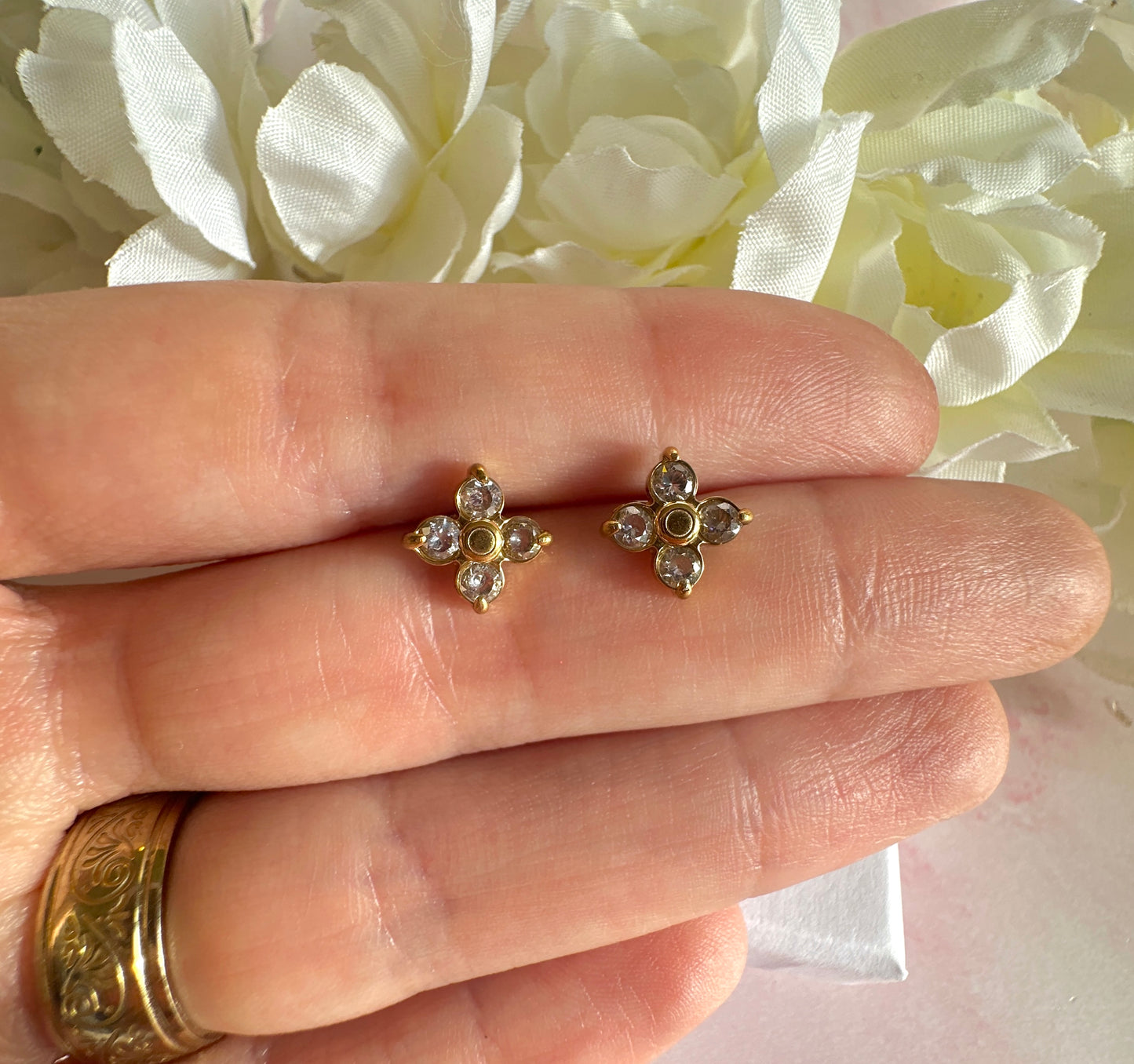 Gold CZ flower stud earrings.