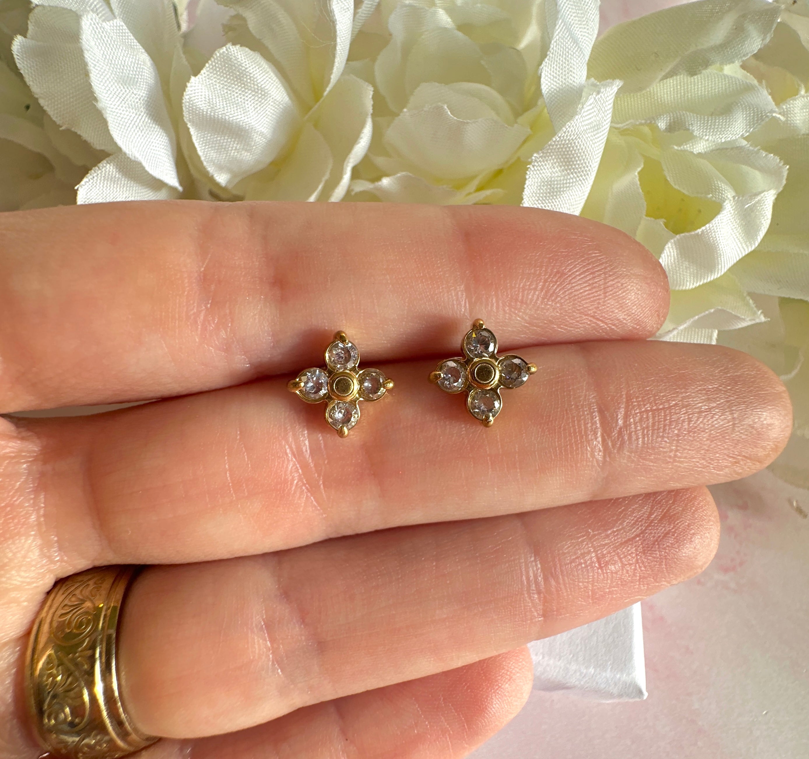 Gold CZ flower stud earrings.