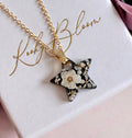Gold Midnight Pearl Star necklace.