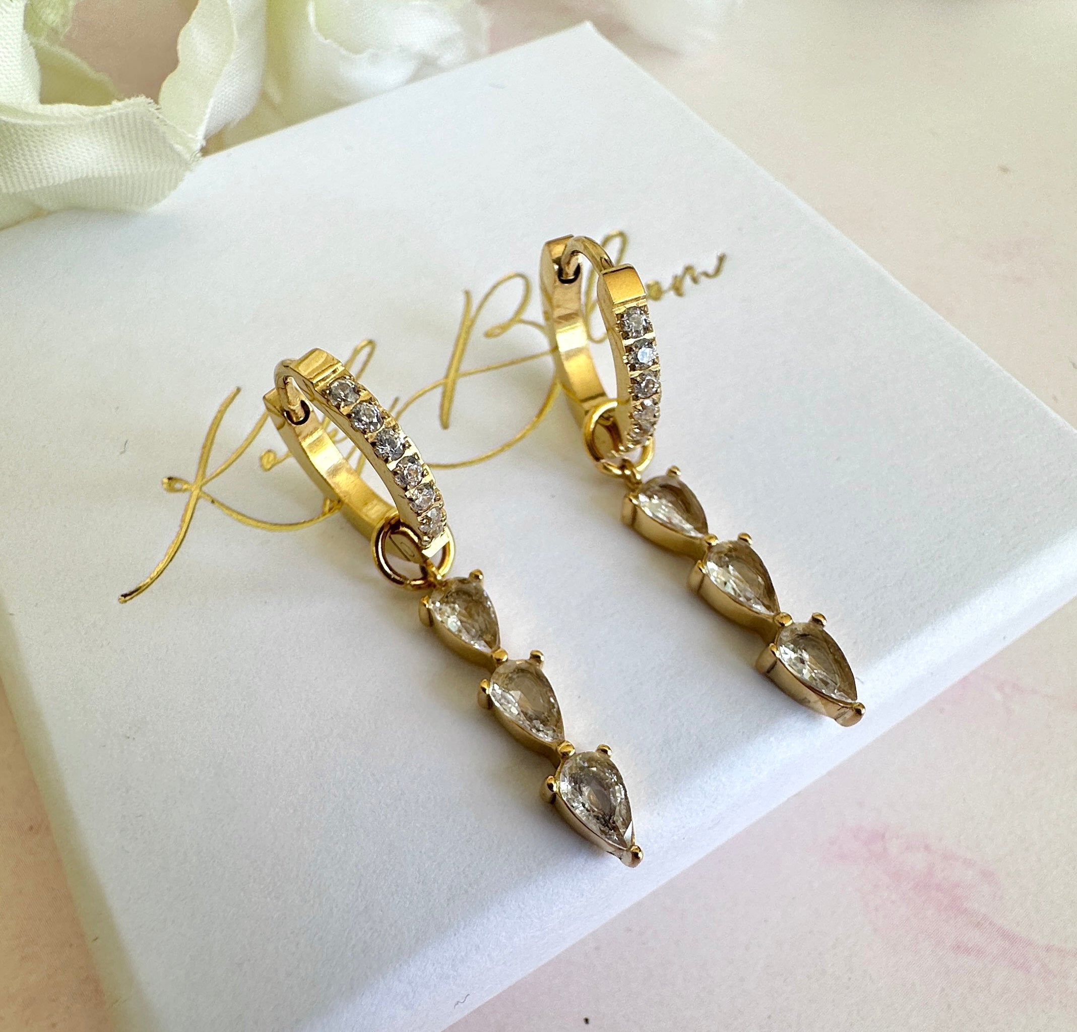 Gold Triple CZ Drop huggie earrings.