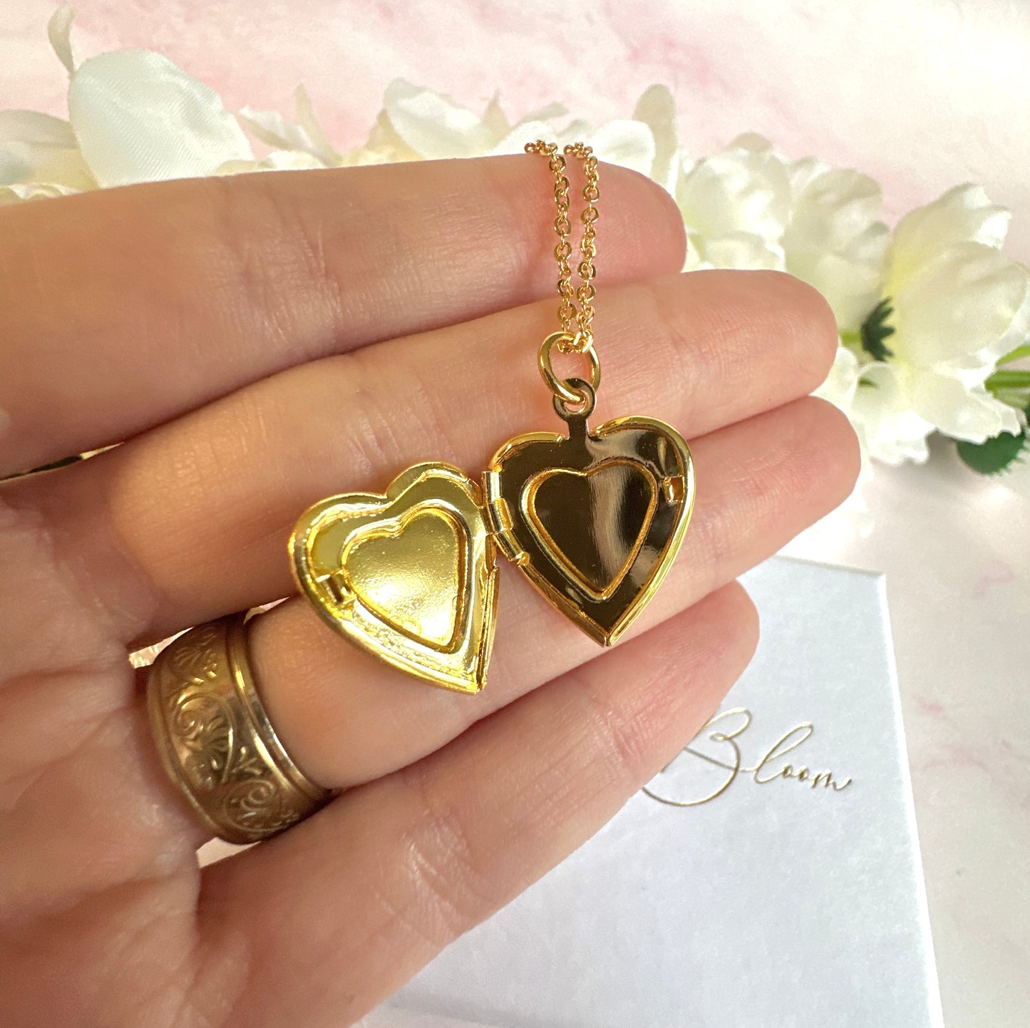 Gold forget me not flower heart locket necklace.