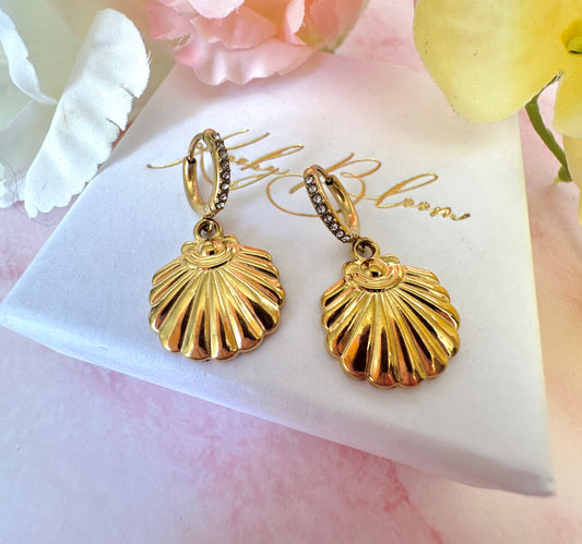 Gold seashell CZ huggie earrings.