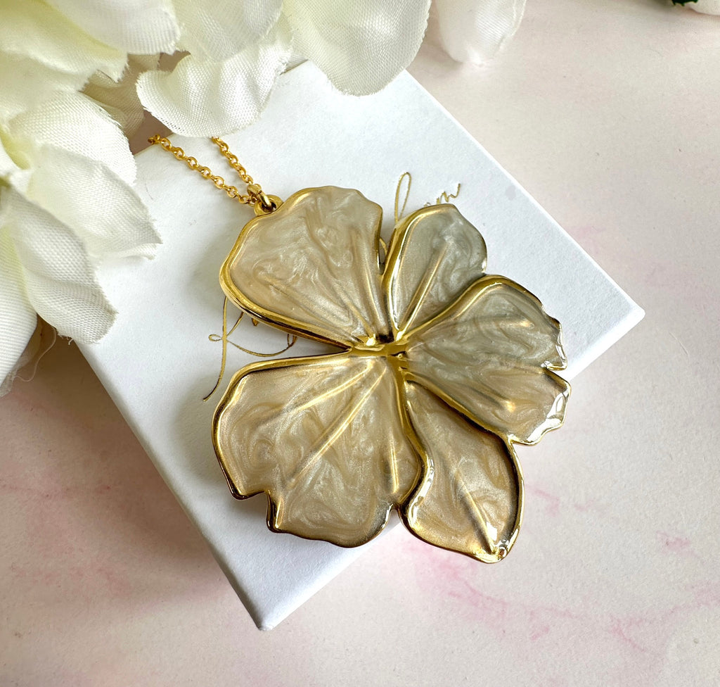 Gold pearlescent oversized flower necklace.