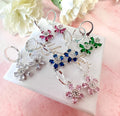 Silver colourful CZ flower huggie earrings .