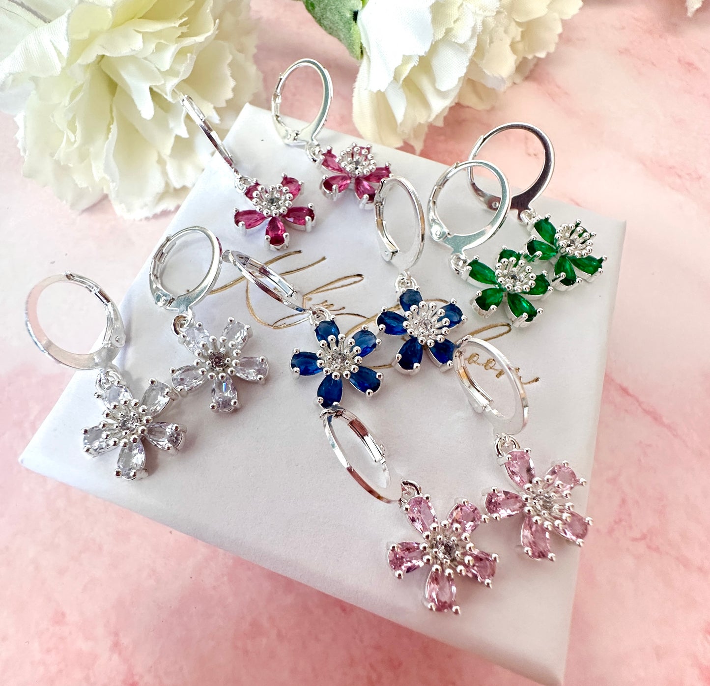 Silver colourful CZ flower huggie earrings .