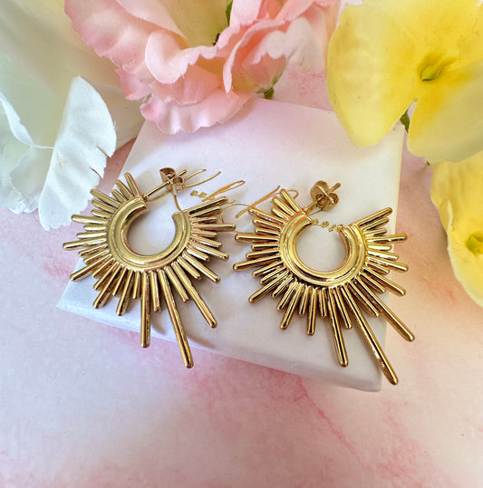 Gold Sun-ray stud earrings.