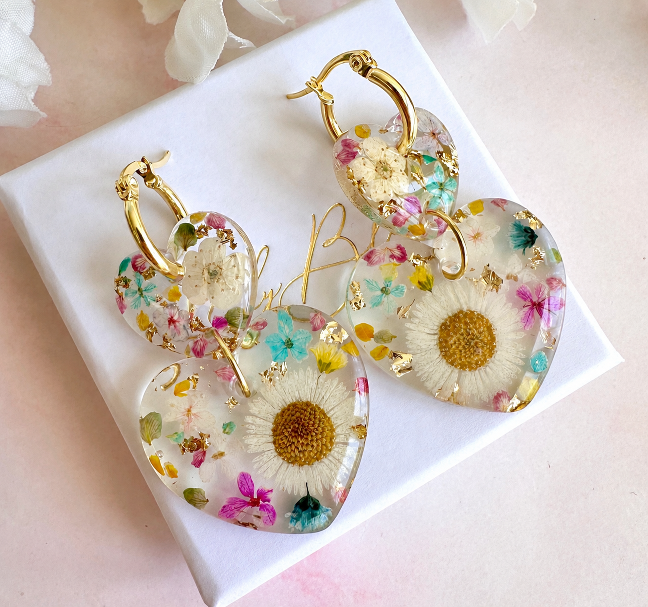 Daisy confetti double heart drop hoop earrings.